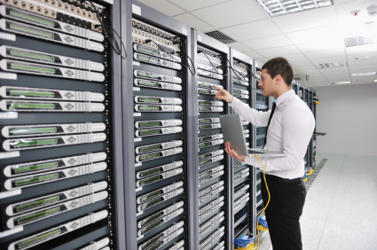 young engeneer in datacenter server room